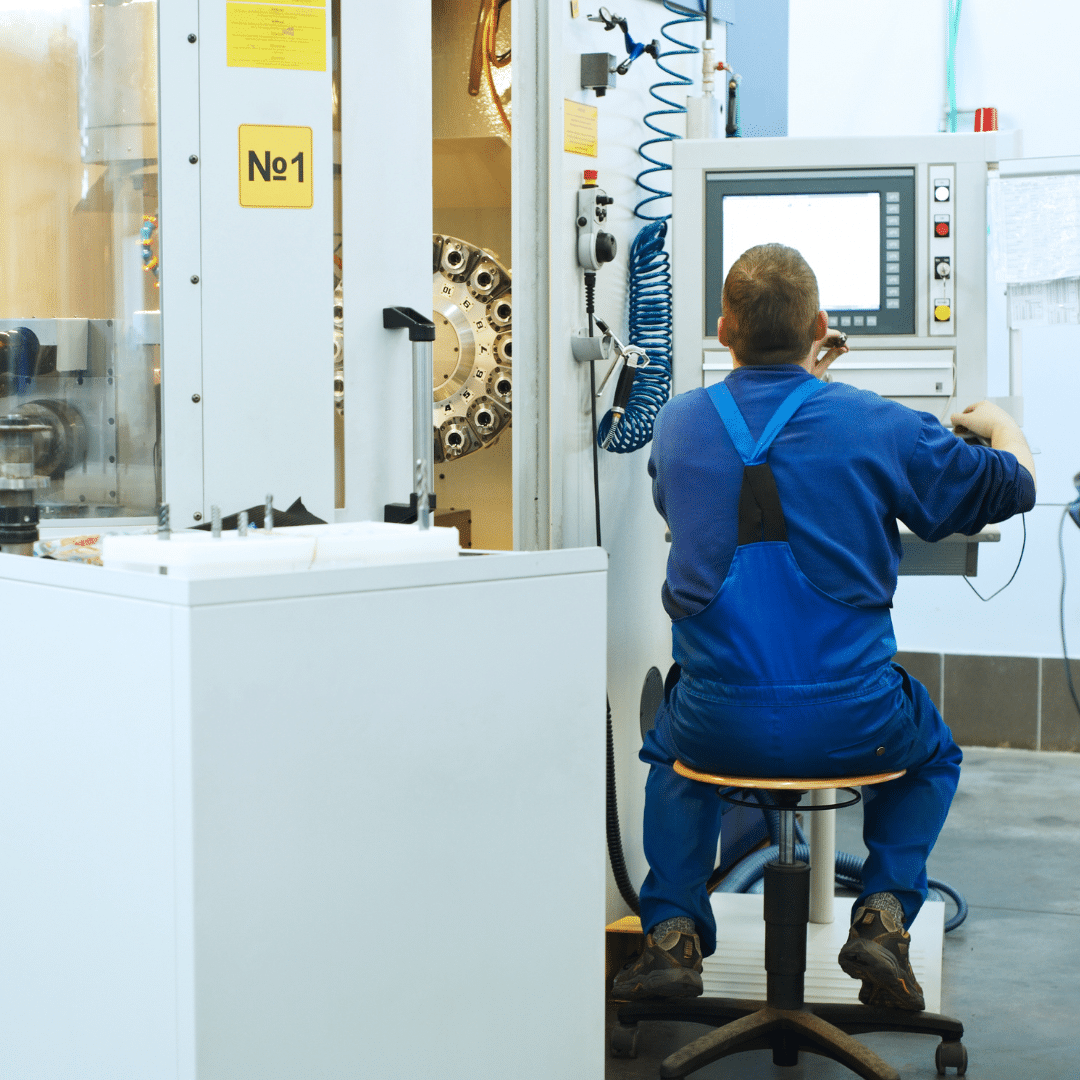 CNC machine maintenance UK: A Midland Oil Group engineer repairing a CNC machine
